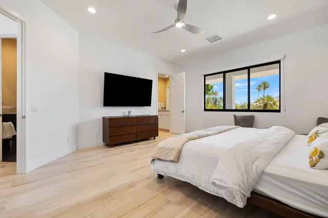 a bedroom with a bed and a flat screen tv