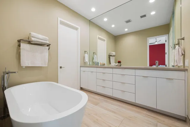 a bathroom with a shower and a sink mirror