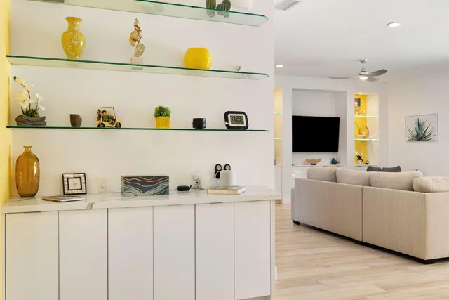 a dining room with furniture a chandelier and wooden floor