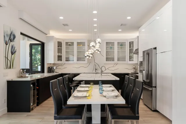 a large white kitchen with a large window
