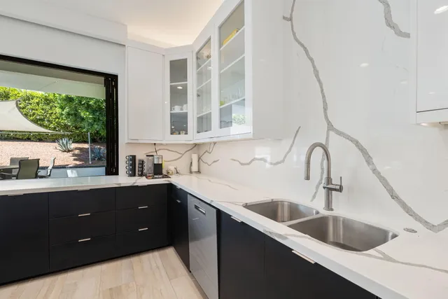 a dining room with furniture and a large window