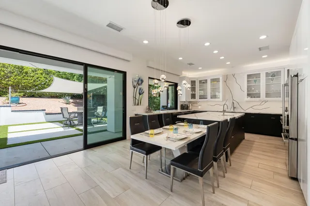 a living room with furniture and view of kitchen