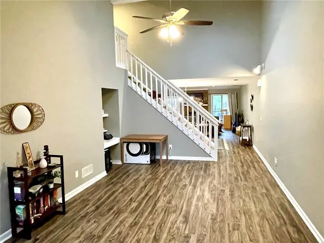a living room with furniture and a dining table