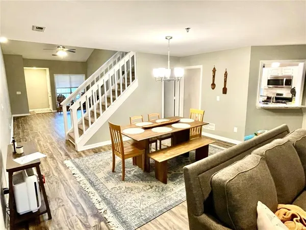 a living room with furniture a rug and a chandelier