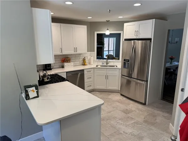 a kitchen with a refrigerator and cabinets
