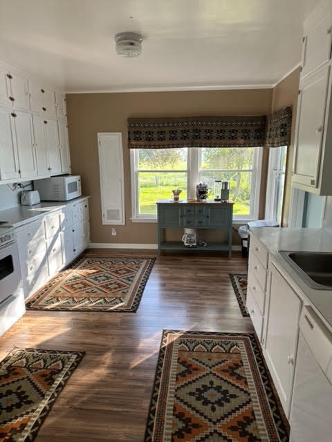 28075 Spring Creek Road Fall River Mills, CA 96028 - Photo 14 of 26 a large kitchen with stainless steel appliances granite countertop a stove a sink dishwasher a refrigerator and wooden floor