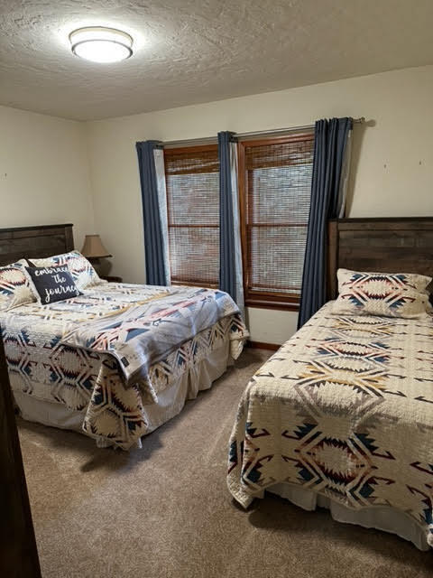 28075 Spring Creek Road Fall River Mills, CA 96028 - Photo 17 of 26 a bedroom with two bed and a window