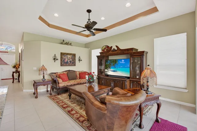 a view of a dining room with furniture a chandelier and window