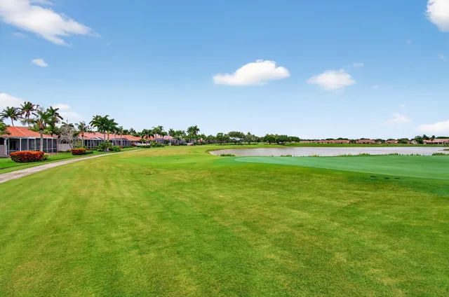 a view of a patio with table and chairs with wooden floor and fence