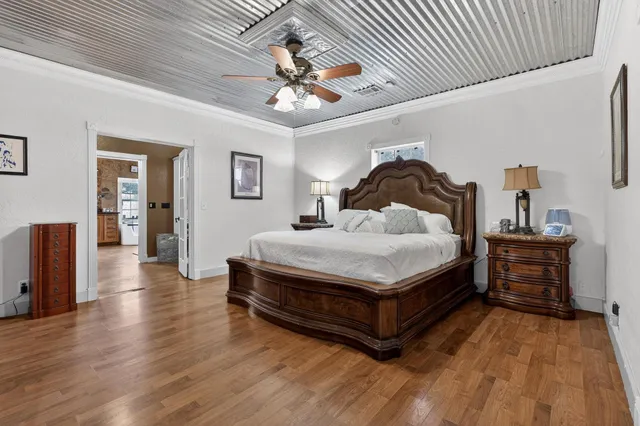a spacious bedroom with a bed and a chandelier