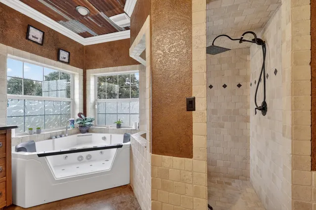 a bathroom with a sink a large mirror and a bathtub