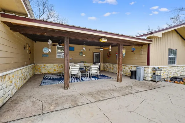 a view of a patio with table and chairs