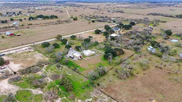 an aerial view of a houses with a yard