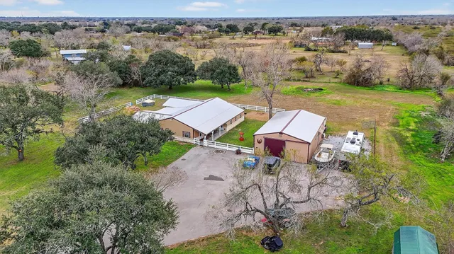 an aerial view of a house with outdoor space and lake view