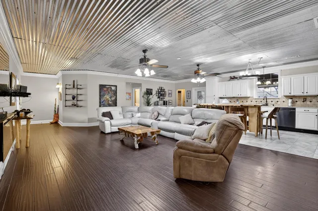 a living room with lots of furniture and kitchen view