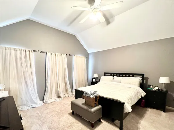 a bedroom with a bed and lamp