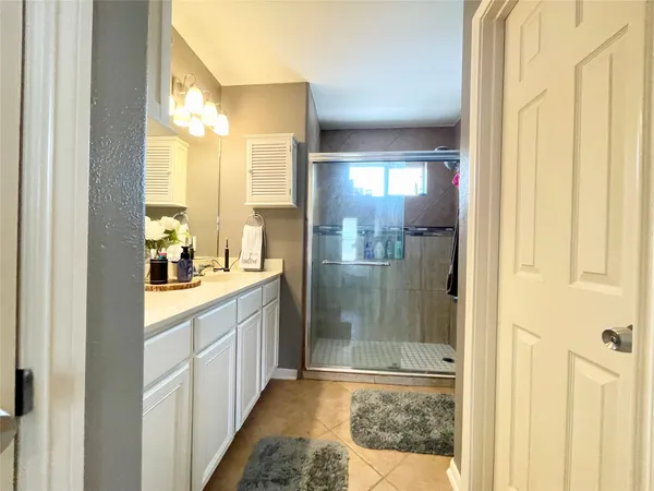 a bathroom with a glass shower door and a glass door