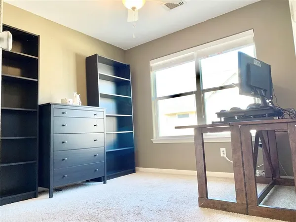 a view of an empty room and a window