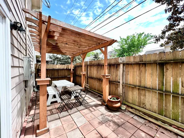 a backyard of a house with barbeque oven table and chairs