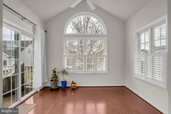 a view of a livingroom with wooden floor and a flat screen tv