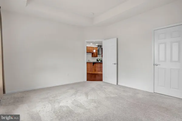 an empty room with windows and closet