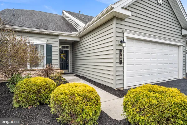 a view of staircase with wooden floor and pendant lights