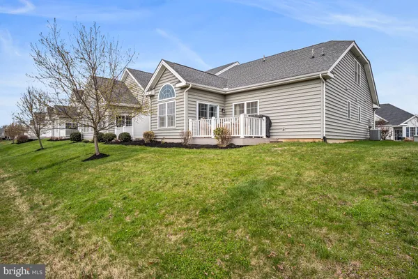 a view of a swimming pool with lawn chairs and a fire pit