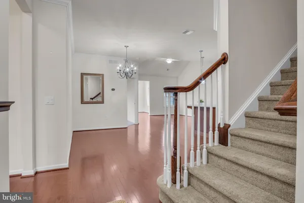 wooden floor with white walls and windows