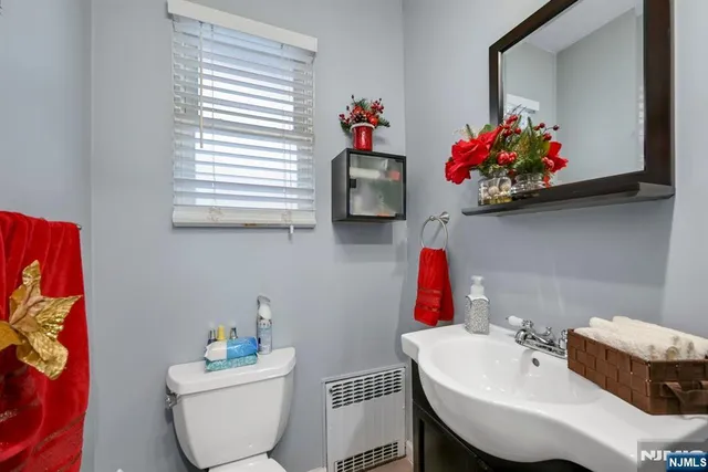 a bathroom with a sink mirror and toilet