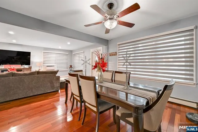 a view of a dining room with furniture and wooden floor