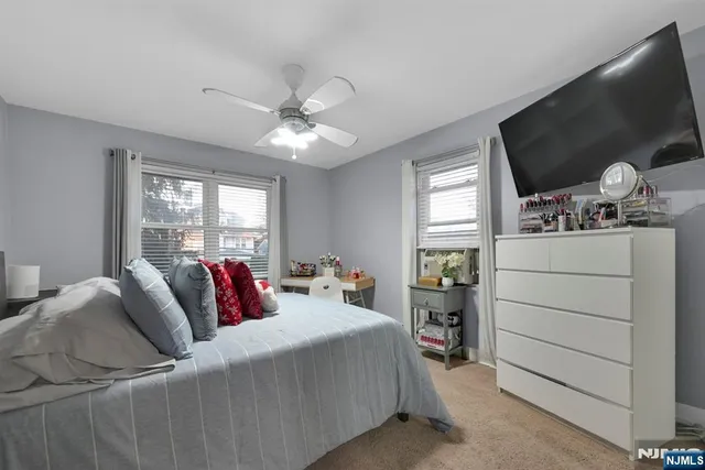 a living room with furniture a flat screen tv and a window