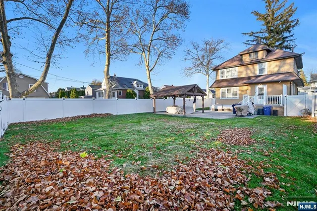 a view of house with backyard and garden