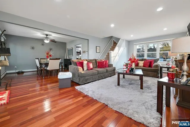 a living room with furniture and wooden floor