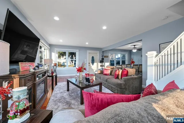 a living room with lots of furniture and a flat screen tv