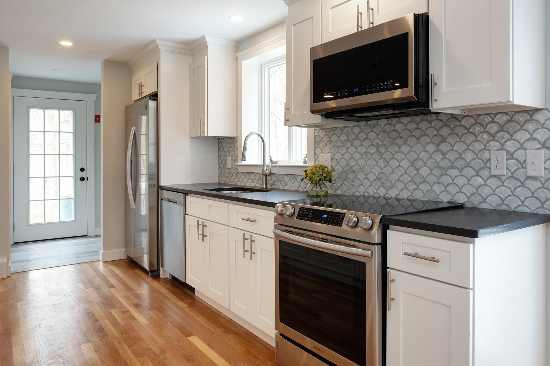 45 Chipman Road Sandwich, MA 02563 - Photo 7 of 30 a kitchen with stainless steel appliances a stove microwave and sink