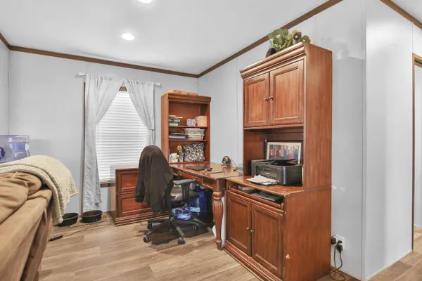 a view of a workspace with furniture and a window