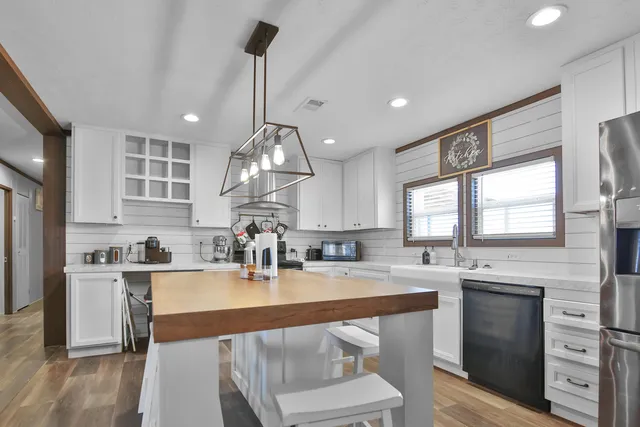 a kitchen with a sink cabinets and window