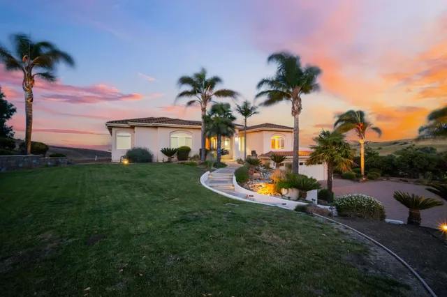 a view of a house with swimming pool and garden