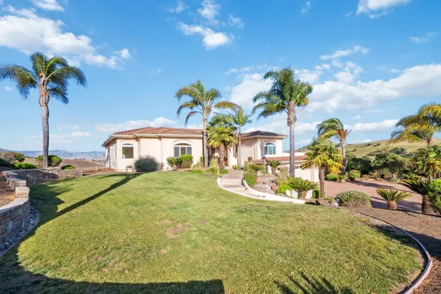 a view of a house with a backyard
