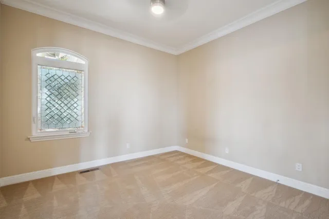 a view of a big room with wooden floor and windows