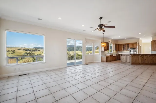 a front view of a house with a yard and potted plants