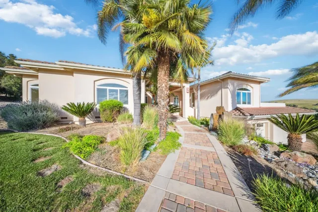 a view of empty room with wooden floor and window