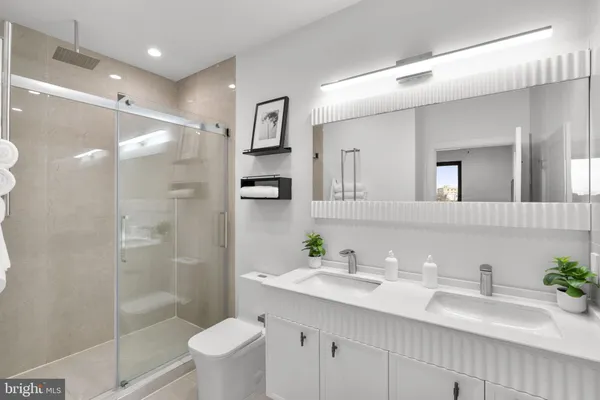 a bathroom with a sink toilet and shower