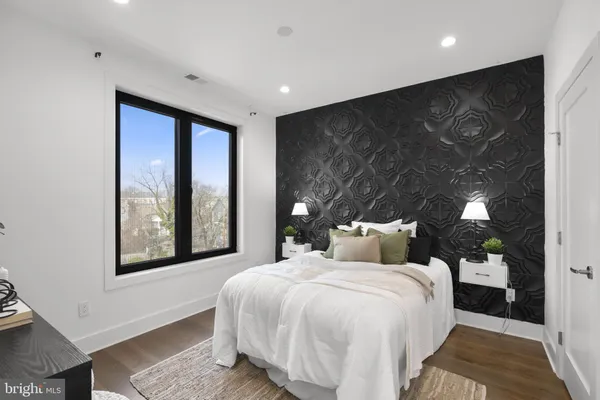 a bed room with a bed and large window
