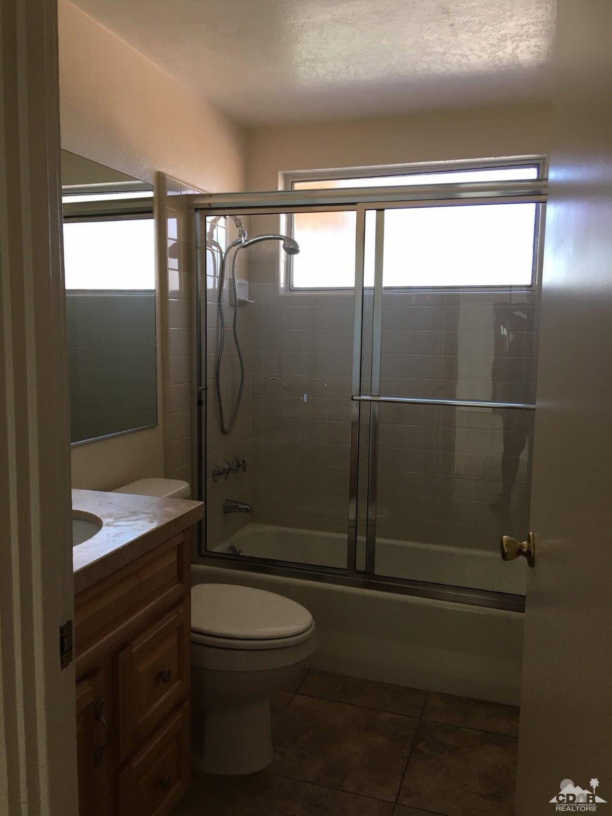 42637 East Veldt Street Rancho Mirage, CA 92270 - Photo 11 of 11 a bathroom with a toilet a sink and shower