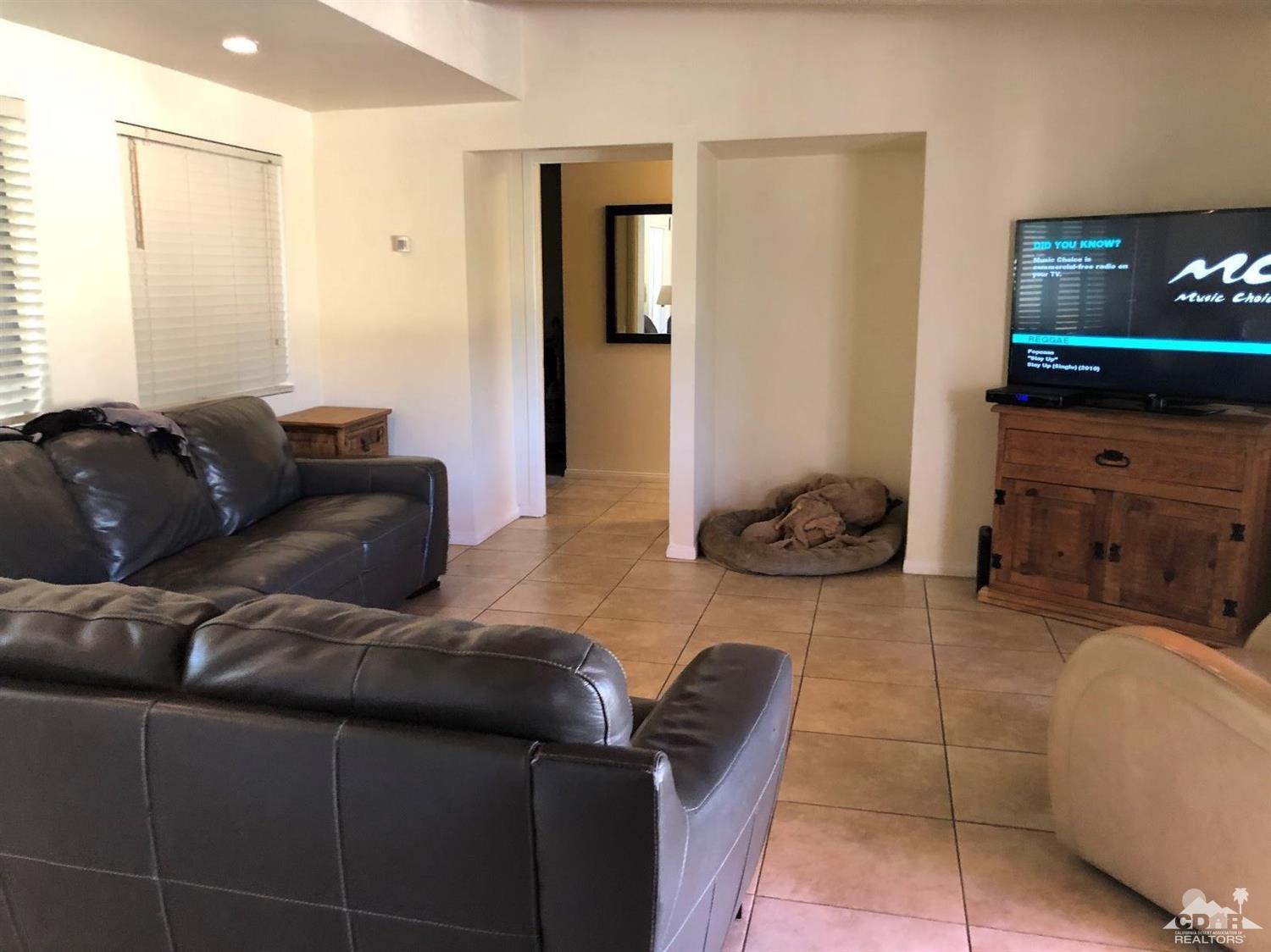 42637 East Veldt Street Rancho Mirage, CA 92270 - Photo 5 of 11 a living room with furniture and a flat screen tv