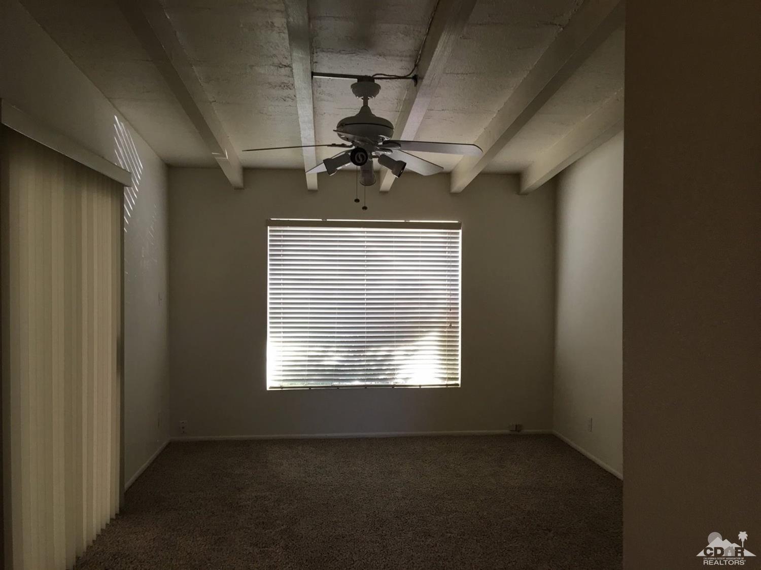 42637 East Veldt Street Rancho Mirage, CA 92270 - Photo 7 of 11 a view of a livingroom with a ceiling fan and window