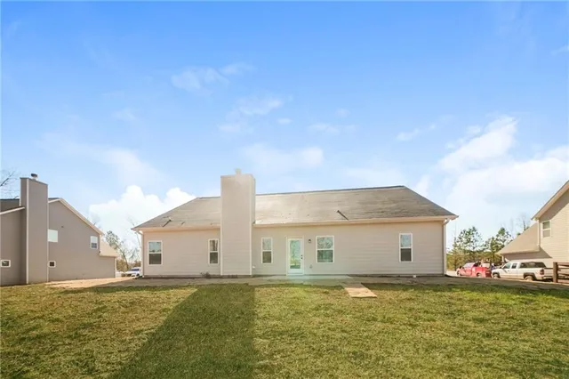 a big house with a big yard and large trees