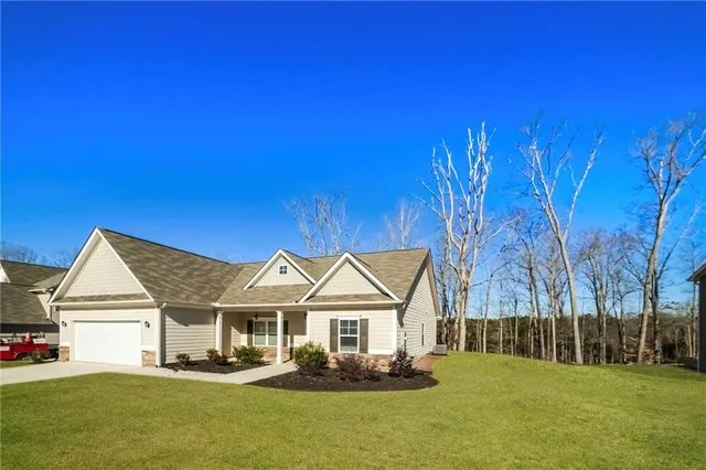 a front view of a house with a yard