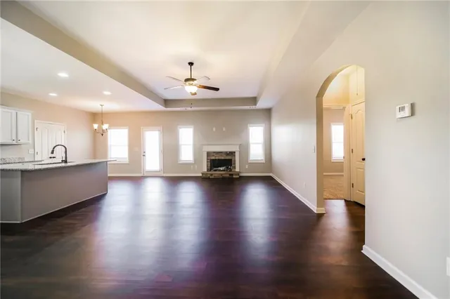 a view of a living room a kitchen and a wooden floor